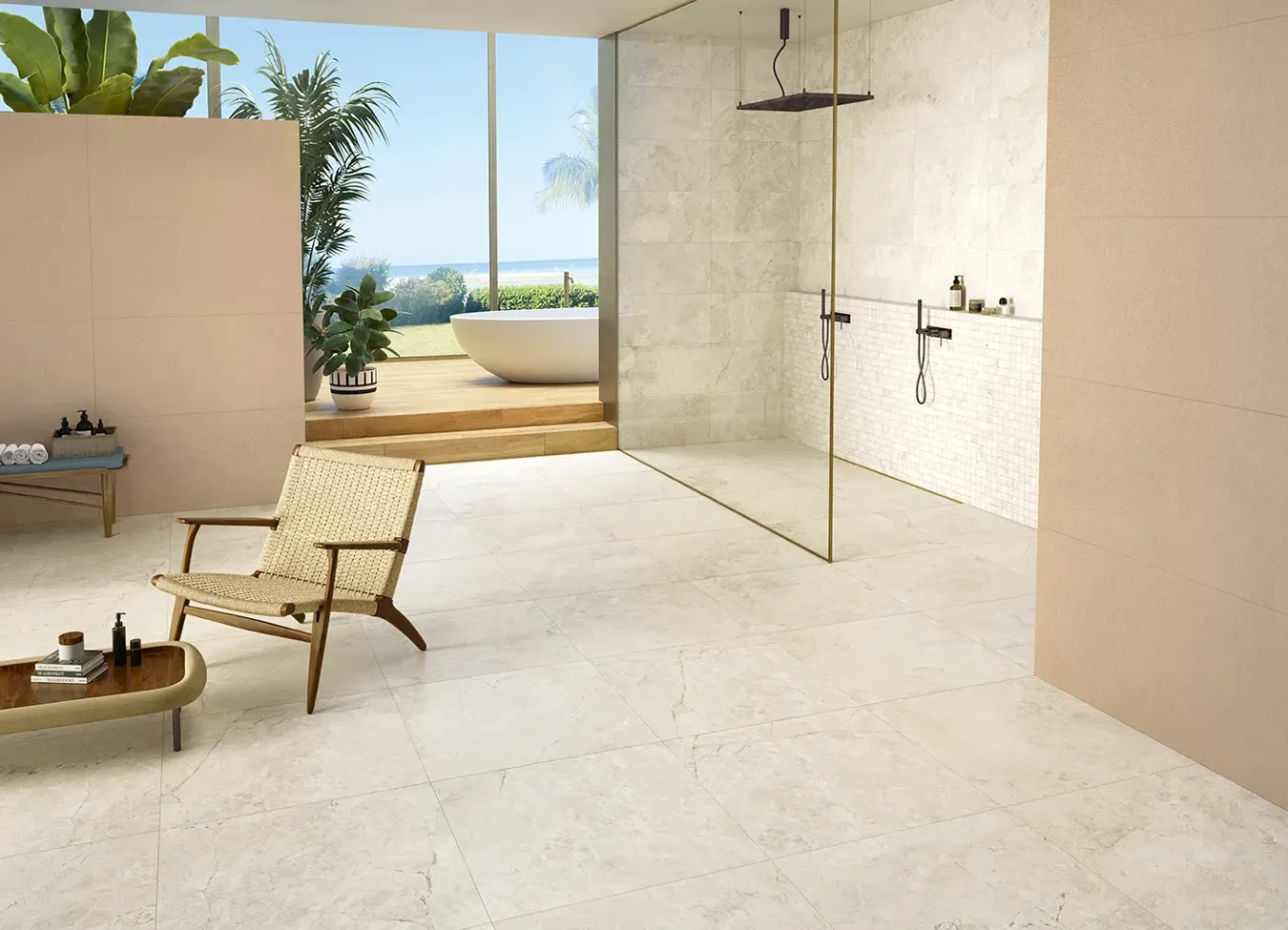 Salle de bain ouverte sur l'extérieur avec receveur de douche effet pierre de la collection Omnia, fusion parfaite de l'intérieur et de l'extérieur.