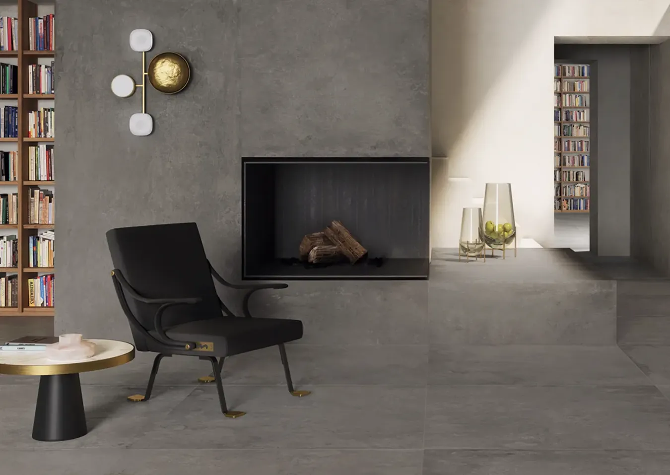 Стильная гостиная с камином в серой плитке под камень, современное черное кресло и золотые акценты