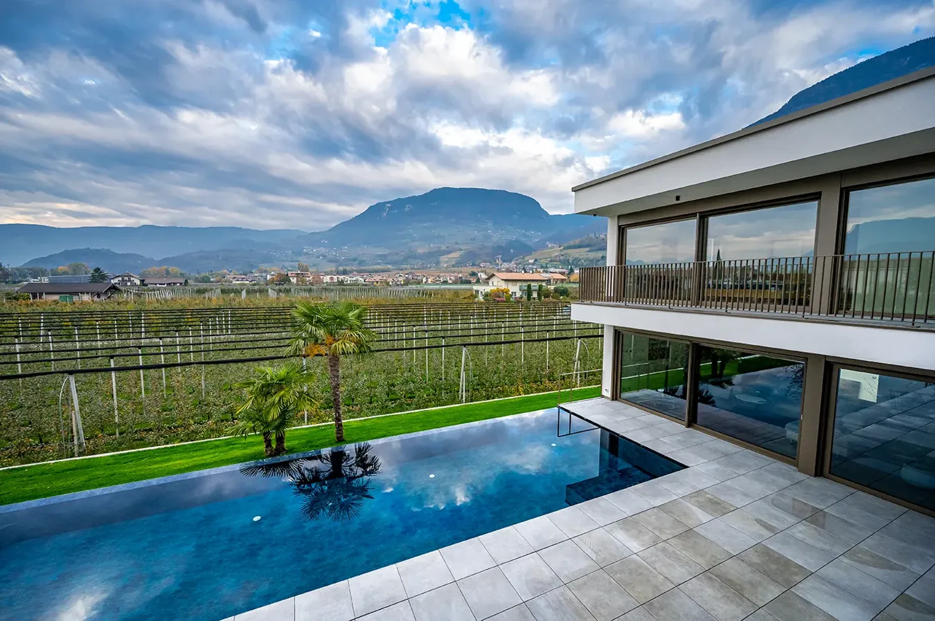 Pool with Moov Grey anti-slip tile edging overlooking mountainous landscape.