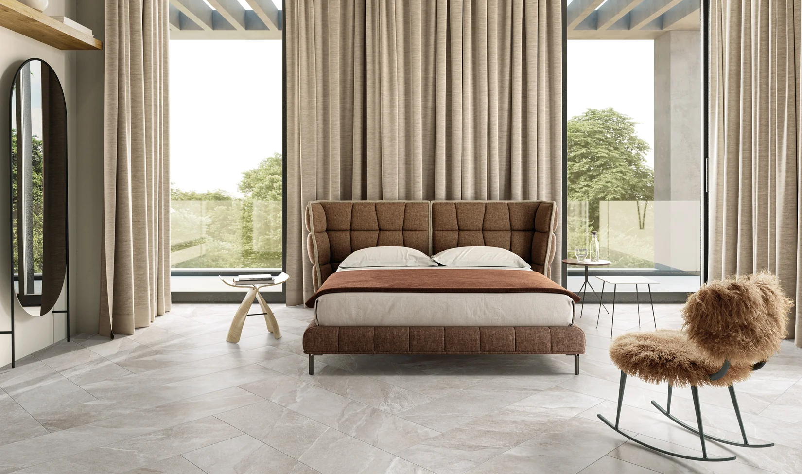 Camera da letto moderna con pavimento in gres porcellanato Ubik colore Grey, letto imbottito marrone, ampie finestre con vista naturale.